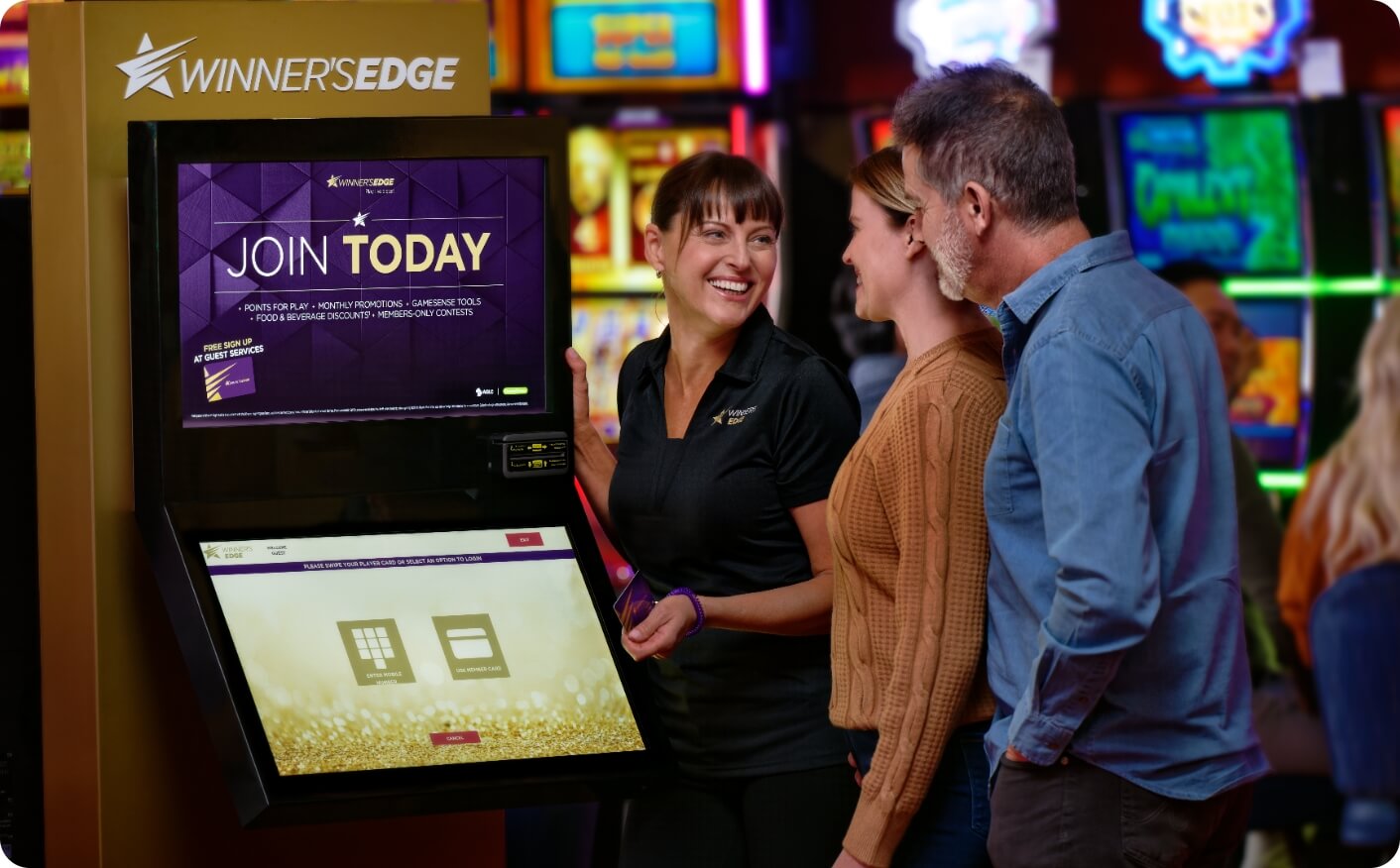 Smiling members standing by a Winner’s Edge ATM