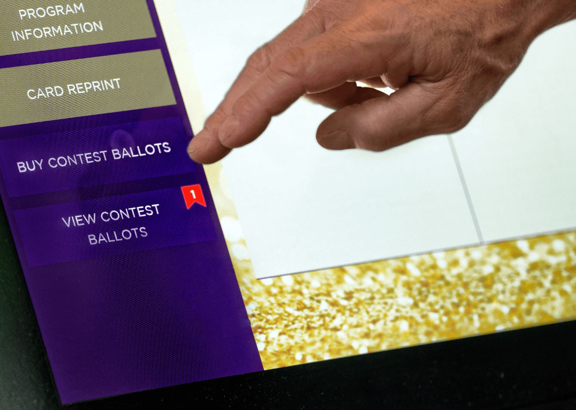 A member’s hand up close using a casino ATM