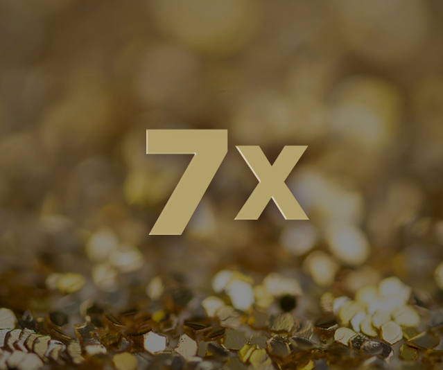  '7X' in the middle with blurred gold sparkles in the background